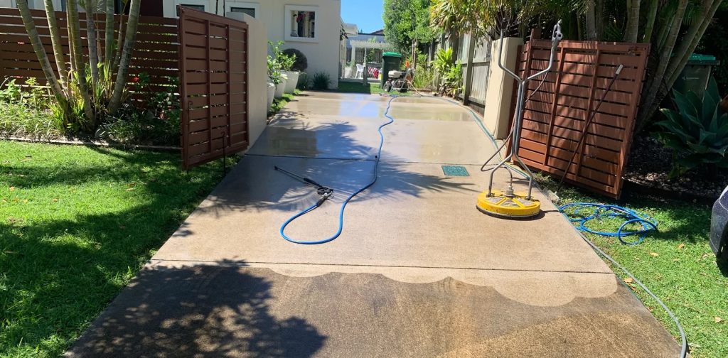 A Plus Pressure Washing Sunshine Coast cleaning a concrete driveway